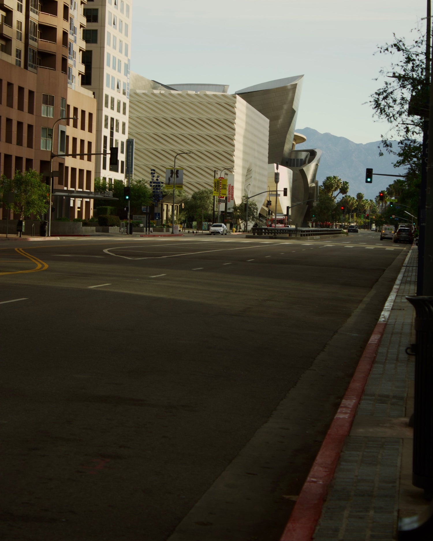 City street with modern architecture and mountains in the background